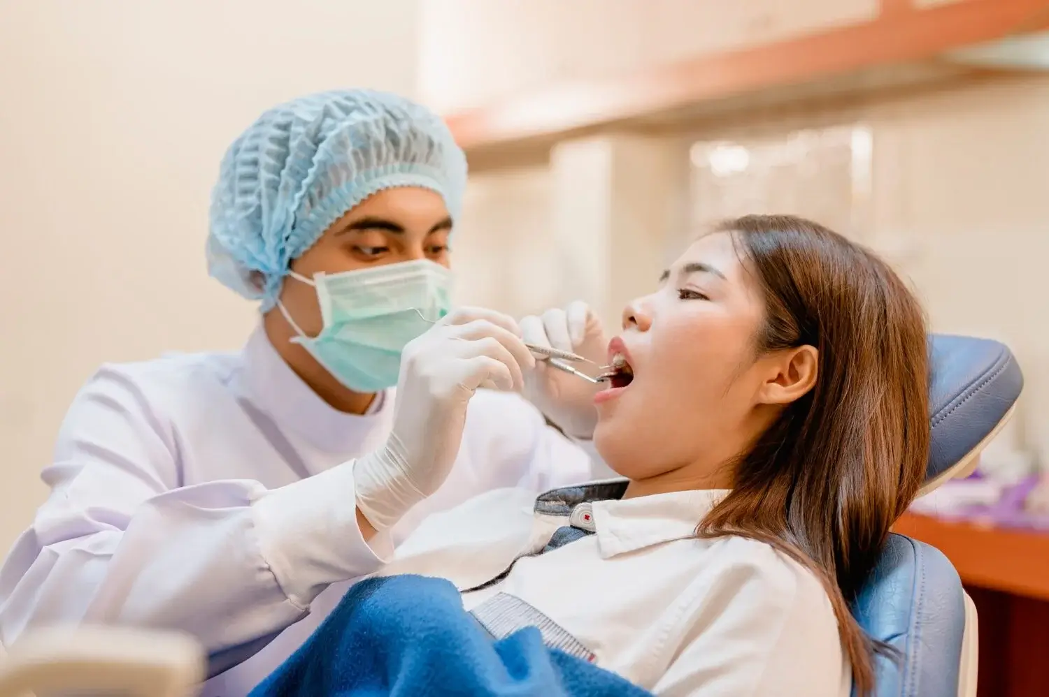 Dentist examining and filling teeth patients in clinic for better dental health and a bright smile.